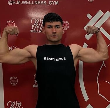 a fitness man in a black tank top and shorts