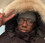 a man in a black jacket and glasses