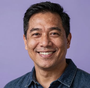 A portrait of a warm and smiling North American person in their thirties, looking directly at the camera with a gentle and empathetic expression, soft studio lighting with lavender accents.