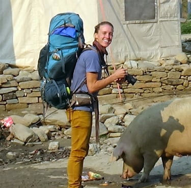 Trekkker taking a photo of a pig