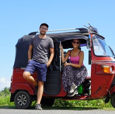 a man and woman standing in front of a tuk tuk tuk