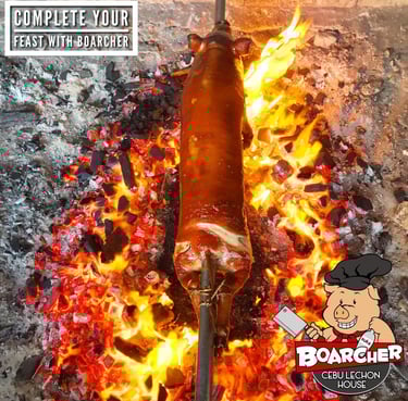 lechon being roasted on a bed of charcoals and flame