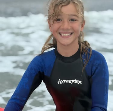 Girl from Montreal happy after a surf lesson in Rye, NH with E Street Surf School