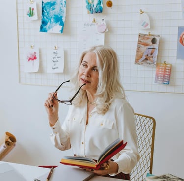 elderly woman thinking about why if she should invest in gold ira with augusta precious metals and the benefits they give