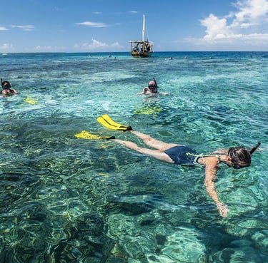 Someone snokelling in Mnemba Island, clear blue water