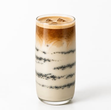 Iced black sesame latte with layered espresso and milk in a tall glass over a white background.