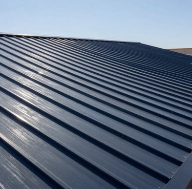 Crisp wide-angle architectural photograph of a premium residential metal roof in Hobbs, NM, under high-contrast bright desert sunlight, showcasing flawless alignment and clean steel gray seams.