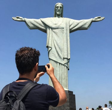 A smiling man with a fresh haircut sitting in a barber chair.