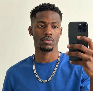 A smiling man with a fresh haircut sitting in a barber chair.