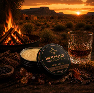 High Desert Grooming Co. beard butter tin on a rustic table near a campfire and desert sunset.