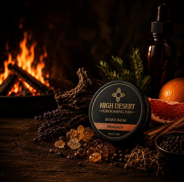 Monarch beard balm tin by High Desert Grooming Co with natural resin and fireplace background.
