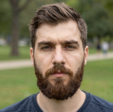 A happy young man holding a collection of Pokémon cards with a bright smile.