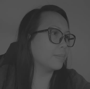 Profile of Jocelyn Batulan with long dark hair wearing stylish black eyeglasses in portrait.