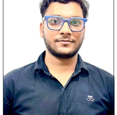 a man with glasses and a blue shirt