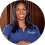 a woman in a blue shirt smiling