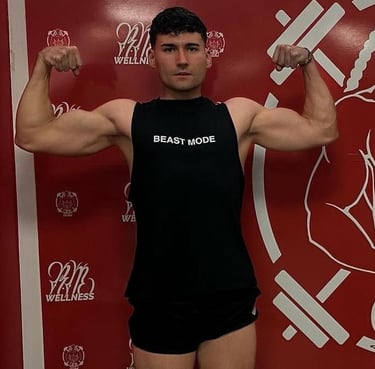 a fitness man in a black tank top and shorts