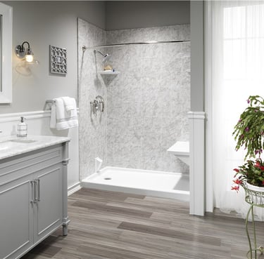 Elegant walk-in shower with marble walls and gray vanity from Toledo New Bath bathroom remodel.