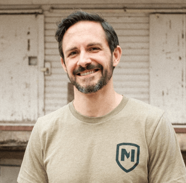 white man smiling at camera