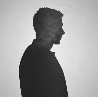 A band performs on stage with vibrant lighting effects. The lead singer, holding a microphone and wearing casual attire with a plaid shirt tied around the waist, sings passionately into the microphone. Other band members play instruments, including electric guitars. The background features colorful stage lights creating a dynamic atmosphere.