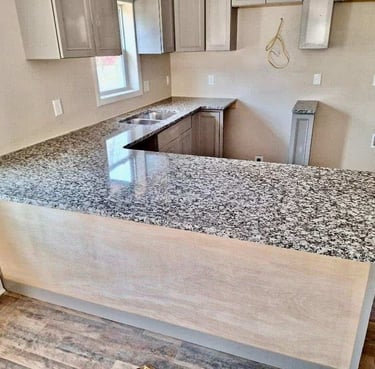 "Light gray granite with natural veining on display