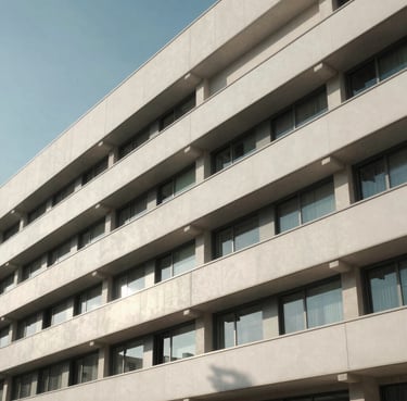 A high-contrast architectural crop of a modern hospital facade in Puglia under soft morning light, clean lines, minimalist composition.