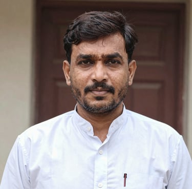 A happy middle-aged Bangladeshi man holding a book and smiling warmly.