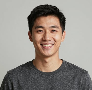 A smiling plumber fixing a kitchen sink with tools in hand.