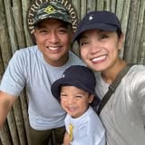 a man and woman with their child posing for a photo