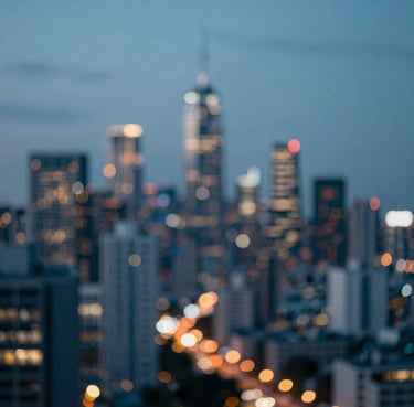 An artistic blur of city lights at dusk, using the palette colors #0D1B2A, #415A77, and #778DA9 to create an atmosphere of modern energy and creative possibility.