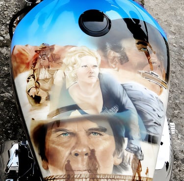 Custom airbrushed motorcycle gas tank featuring portraits of characters from classic Western films.