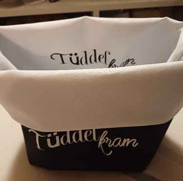 a basket with a white and black basket with a name on it