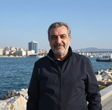 A young man holding a sleek perfume bottle, smiling confidently.