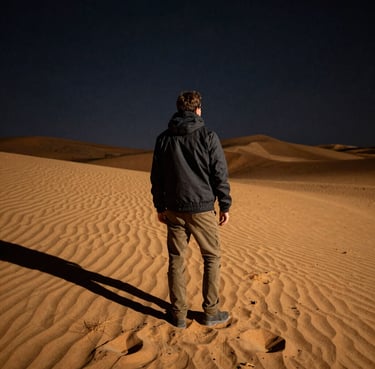 A candid portrait of a smiling traveler holding a camera against a sunset backdrop.