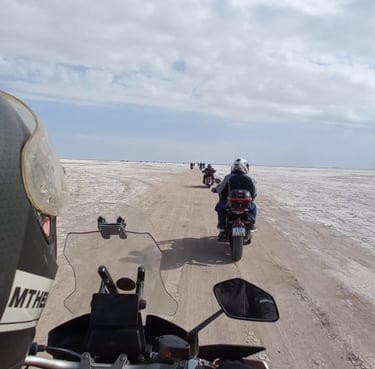 a person riding a motorcycle on a dirt road