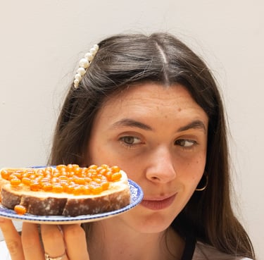 Bláithín Breathnach for Beads on Toast! Girl looking at plate of real toast covered with orange beads