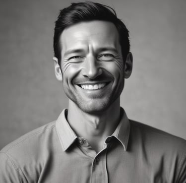 A gloved hand holds a pair of pruning shears in a vineyard. The vineyard rows stretch into the distance, showing neatly maintained vines in a field with visible bare earth and sparse grass.