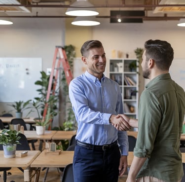  John D. small business owner smiling with consultant in Albany coworking office