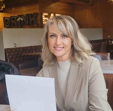 a woman sitting at a table with a piece of paper