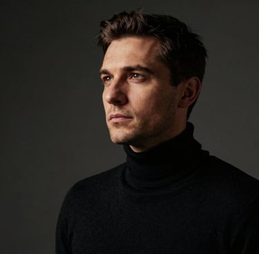 Professional portrait of a Lead Photographer, a Romanian man in a black turtleneck, looking into the distance with a sophisticated gaze, soft bronze-gold side lighting, cinematic dark mode aesthetic.