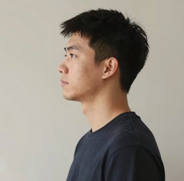 Smiling woman holding car keys standing next to her vehicle in a sunny parking lot.