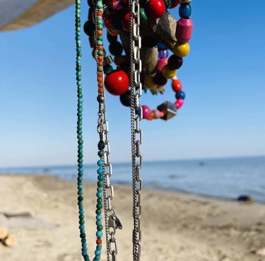 Handmade beaded necklaces at the beach.