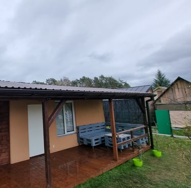 a small house with a bench and a bench in the yard