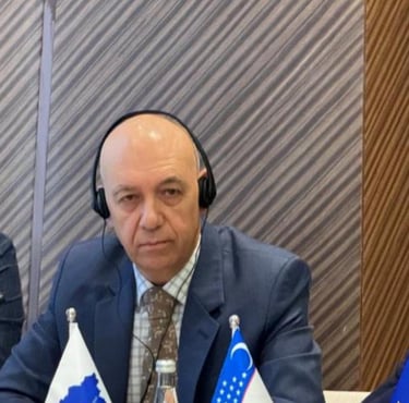 a man in a suit and headphones sitting at a table