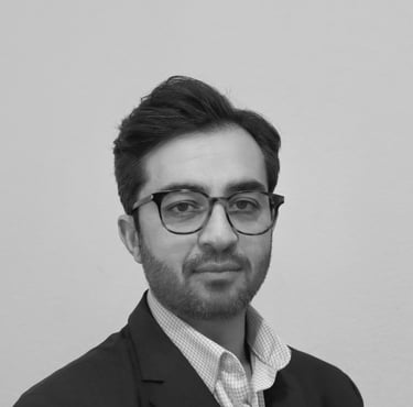 a man in a suit and glasses posing for a picture