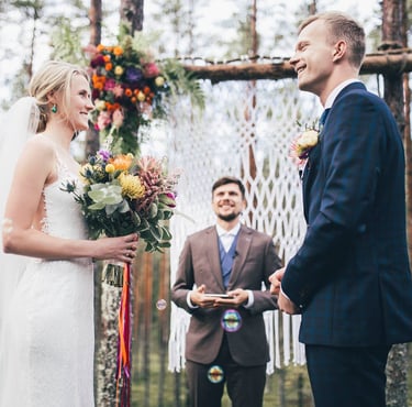 a bride and groom are getting married in a forest