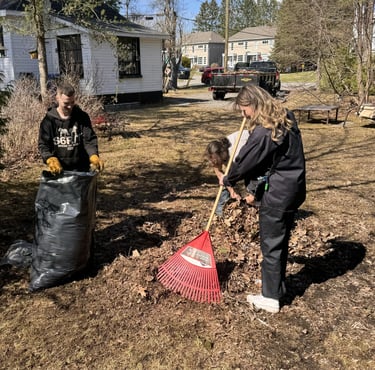employees raking leaves with gcg truck in the backround