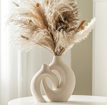 Modern ceramic vase set of 2 styled with dried pampas grass on a table, featuring neutral home decor in minimalist interior.