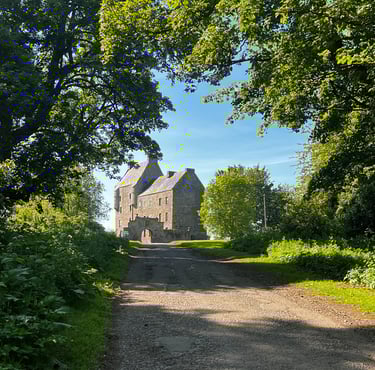 Path leading uphill with midhope castle (lallybroch) at the top