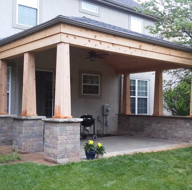 Paver patio with a custom cedar pavilion and granite bar top