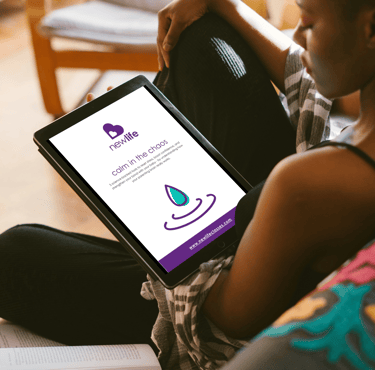 photo of woman on sofa reading 'calm in the chaos' guide on her tablet.